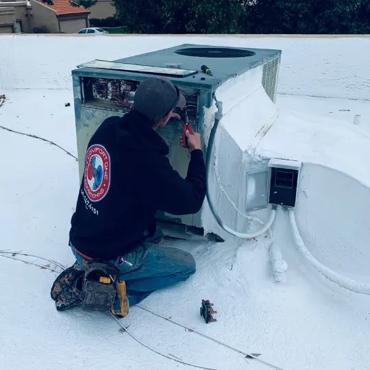 When to Switch from AC to Heat in Arizona: Essential Tips 4 Our technician doing a seasonal maintenance job